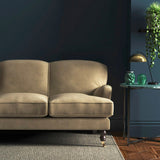 Sofa covered in a brown velvet upholstery fabric