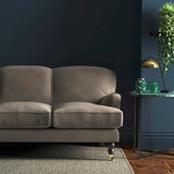 Sofa covered in a grey velvet upholstery fabric