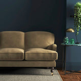 Sofa covered in a brown velvet upholstery fabric