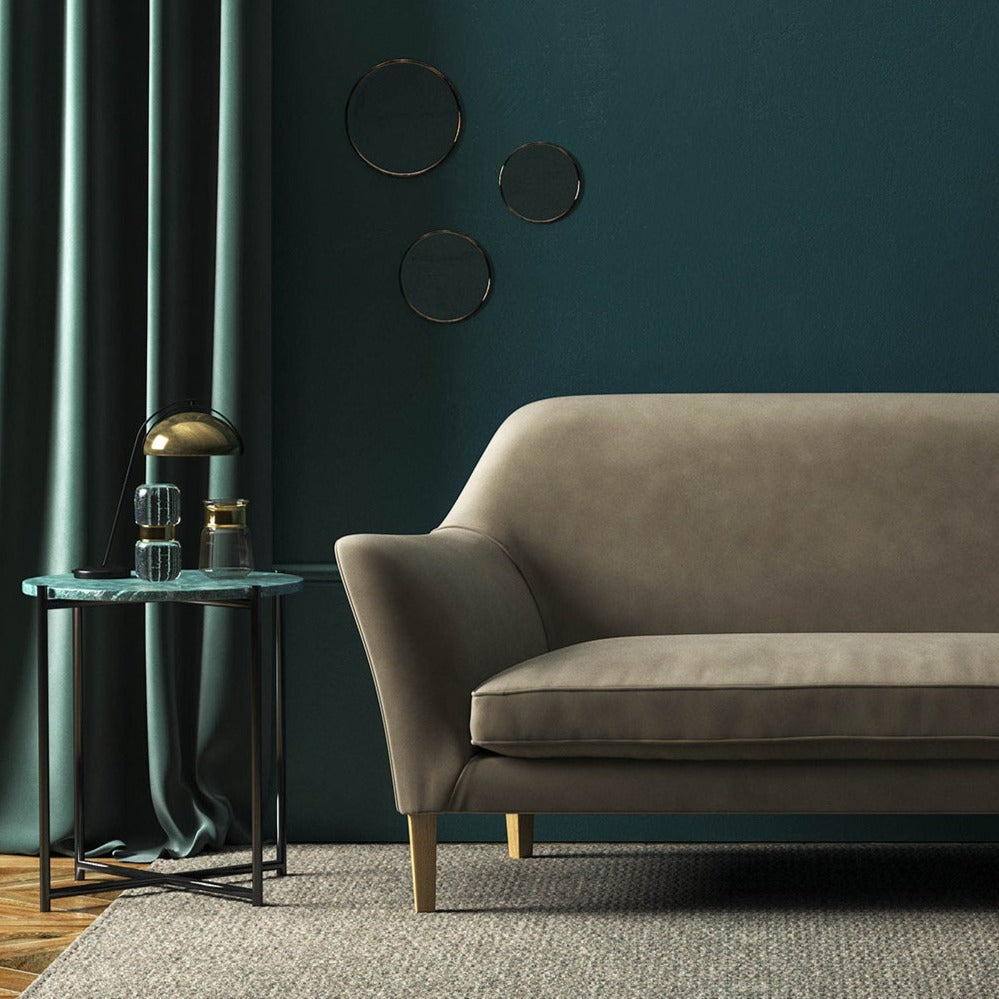 Sofa covered in a brown velvet upholstery fabric 