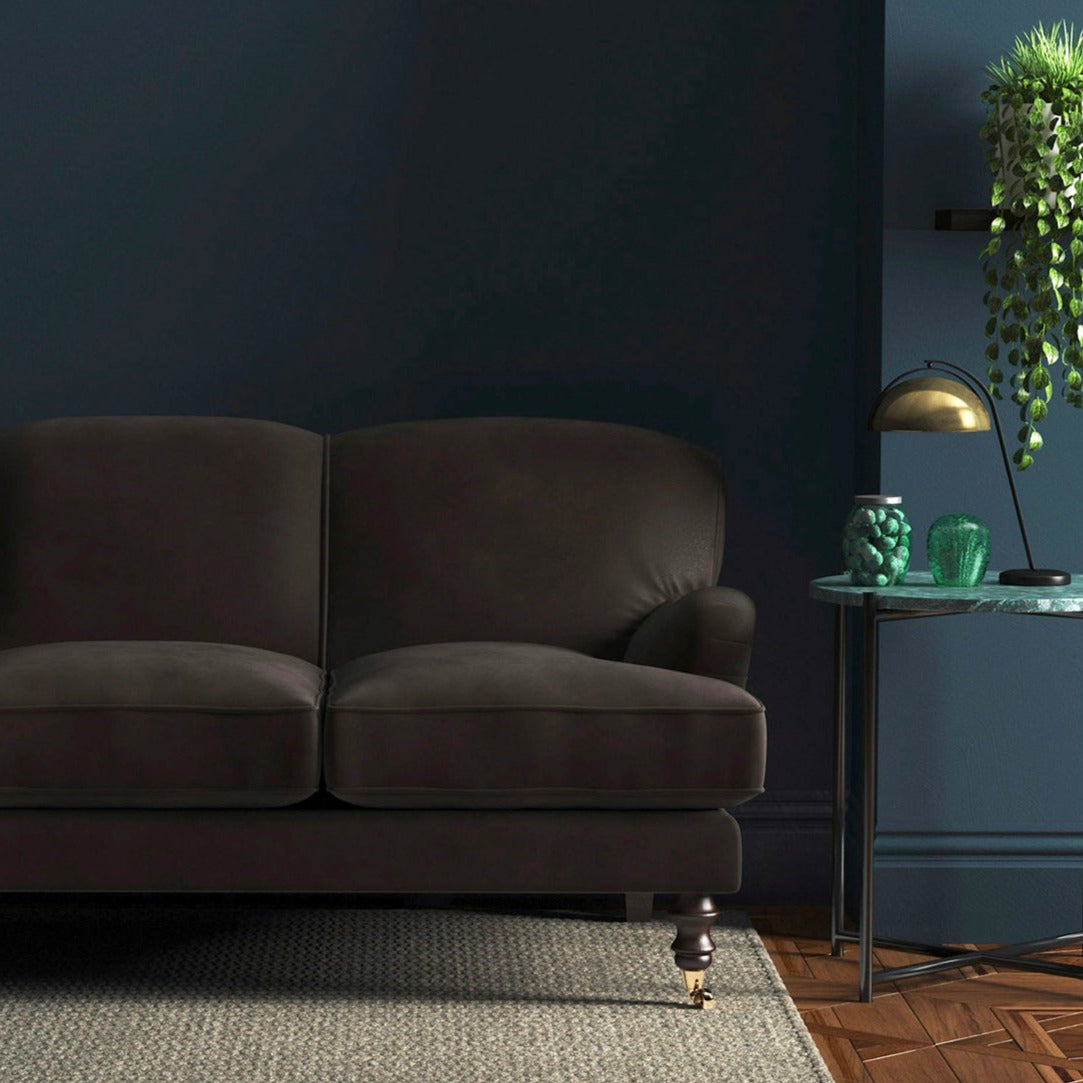 Sofa covered in a brown velvet upholstery fabric