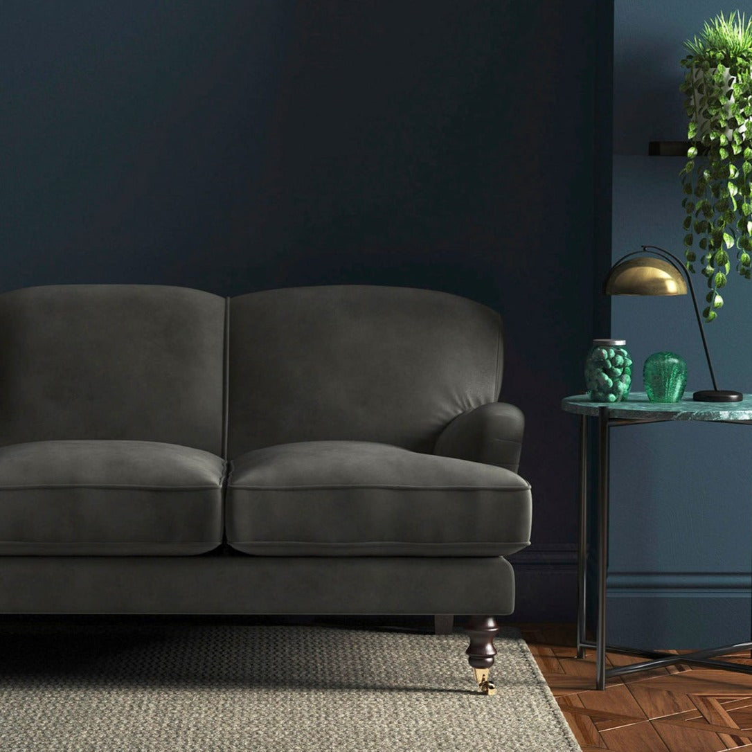 Sofa covered in a grey velvet upholstery fabric