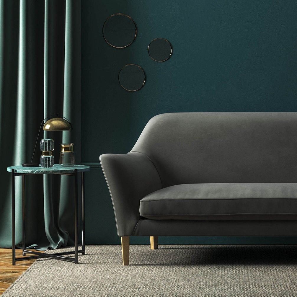Sofa covered in a grey velvet upholstery fabric 