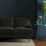 Sofa covered in a grey velvet upholstery fabric