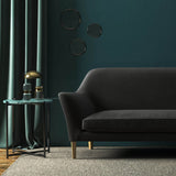 Sofa covered in a grey velvet upholstery fabric 