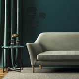 Sofa covered in a grey velvet upholstery fabric 