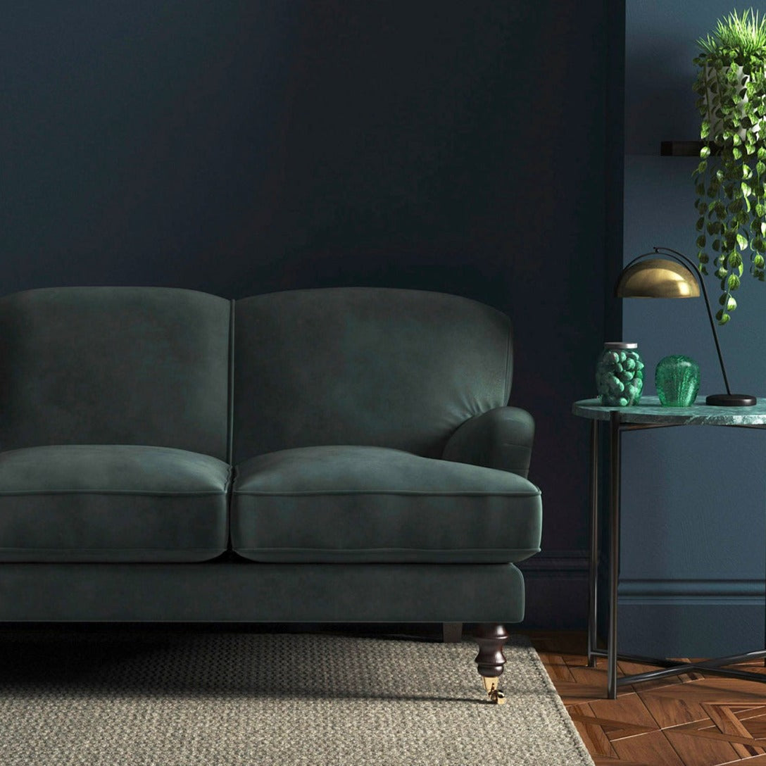 Sofa covered in a grey velvet upholstery fabric
