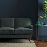 Sofa covered in a grey velvet upholstery fabric