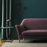 Sofa covered in a purple velvet upholstery fabric 