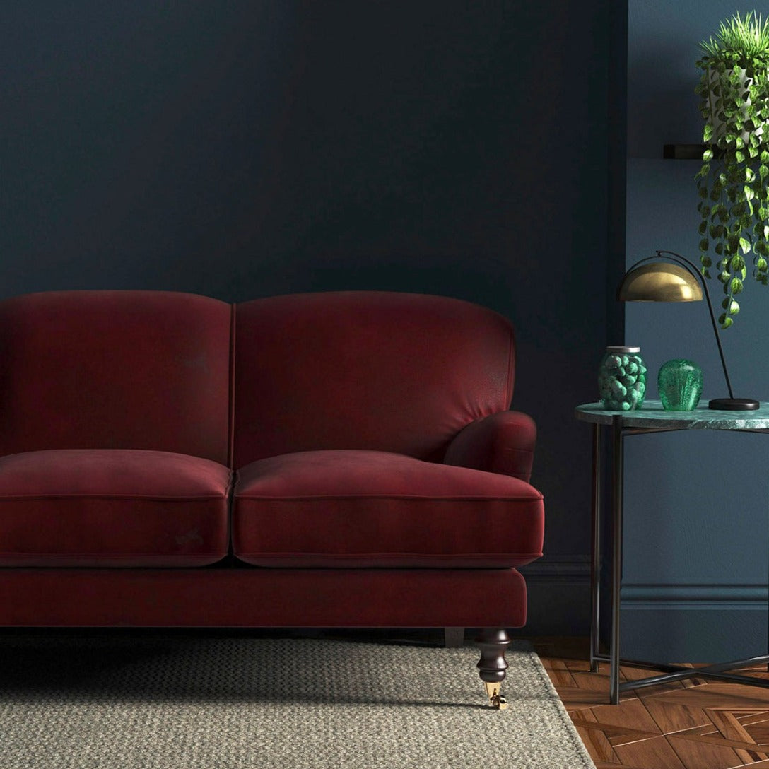 Sofa covered in a red velvet upholstery fabric