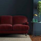 Sofa covered in a red velvet upholstery fabric
