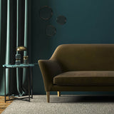Sofa covered in a brown velvet upholstery fabric 