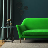 Sofa covered in a green velvet upholstery fabric 