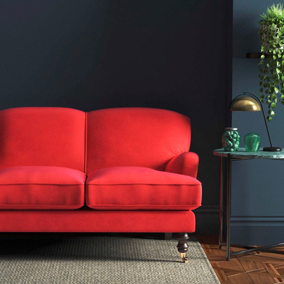 Sofa covered in a red velvet upholstery fabric