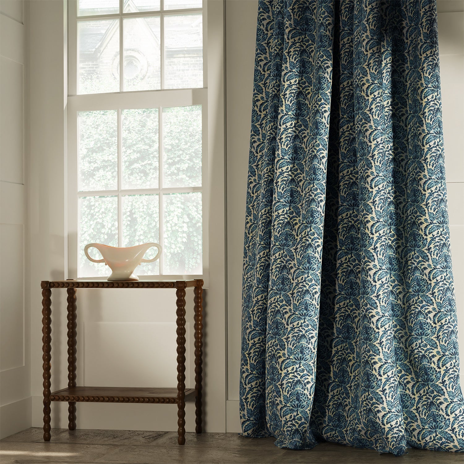 Curtains in a classic blue floral and leaf fabric