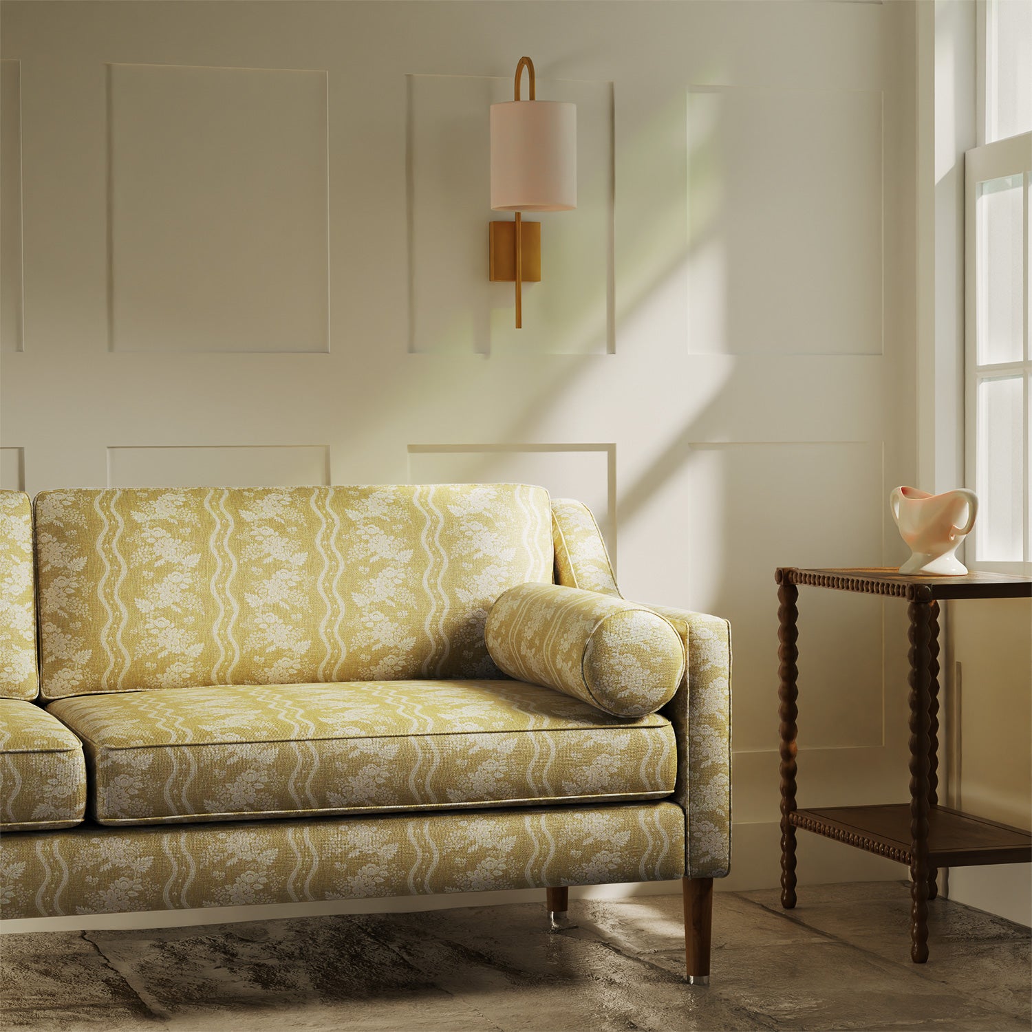 Sofa upholstered in a yellow floral fabric with stripe design