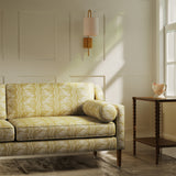 Sofa upholstered in a yellow floral fabric with stripe design