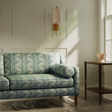 Sofa upholstered in a blue floral fabric with striped design for curtains and upholstery