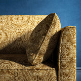 Sofa upholstered in a gold upholstery fabric with intricate jewel like design
