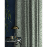 Curtain in a smokey blue and white fabric with intricate jewel design