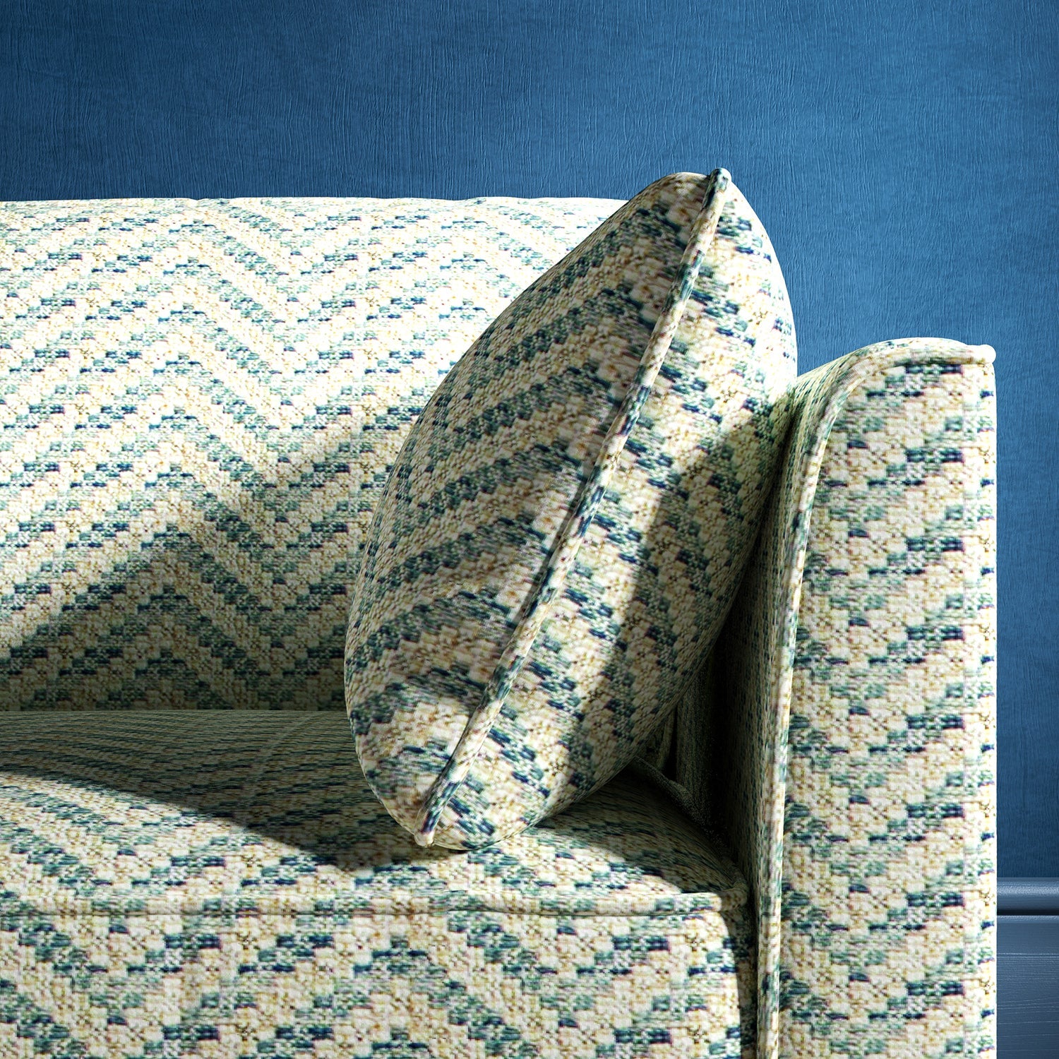 Sofa upholstered in a light blue herringbone upholstery fabric
