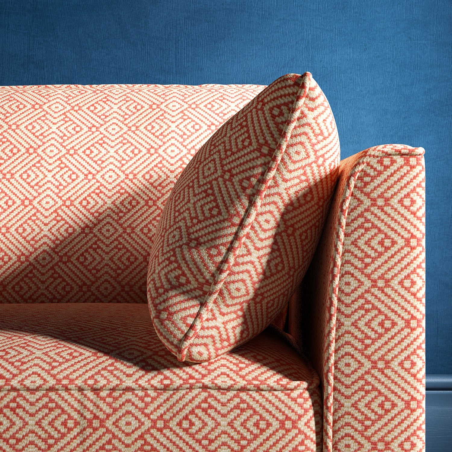 Sofa upholstered in a pink and neutral geometric weave upholstery fabric