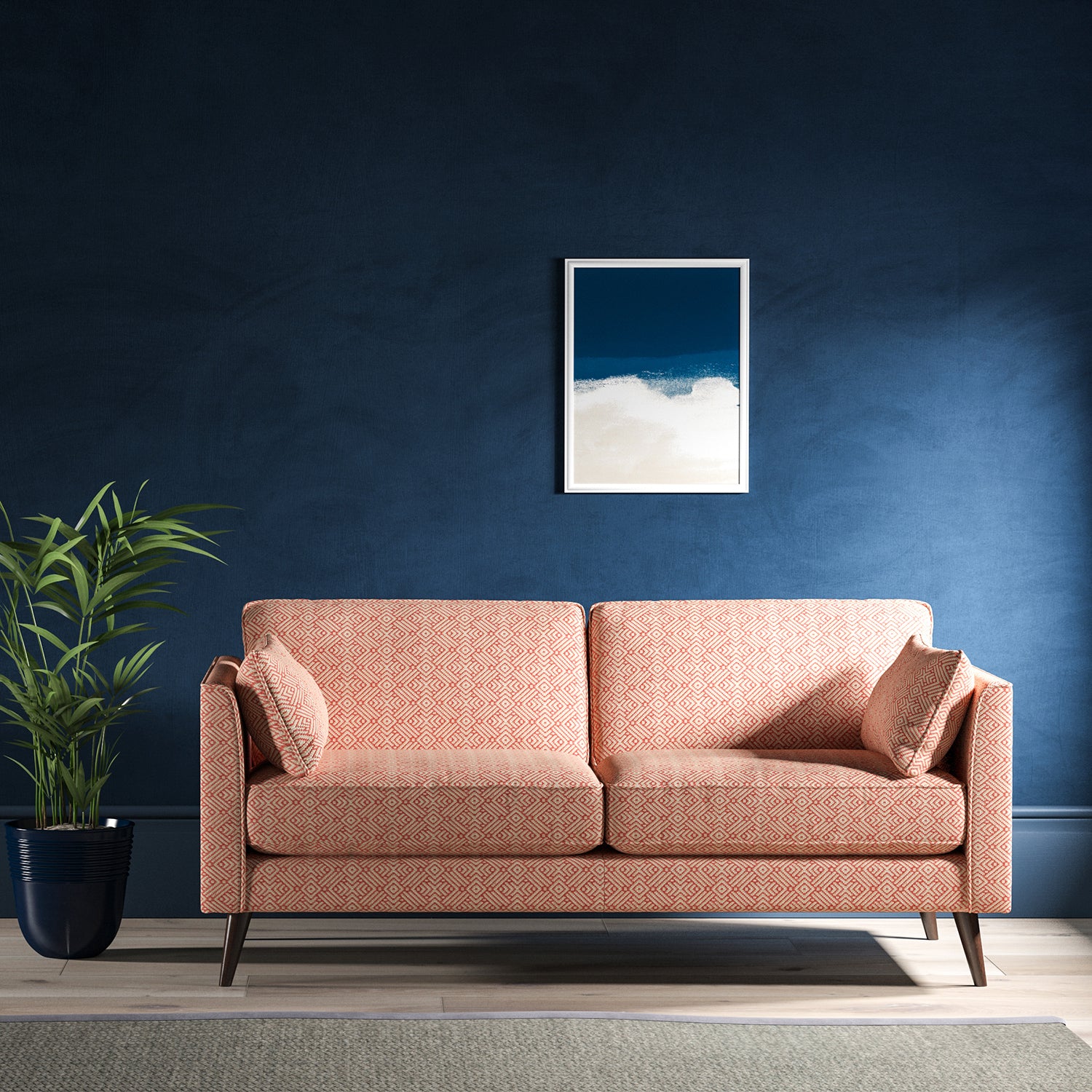 Sofa upholstered in a pink and neutral geometric weave upholstery fabric