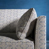 Sofa upholstered in a indigo blue and neutral geometric weave upholstery fabric
