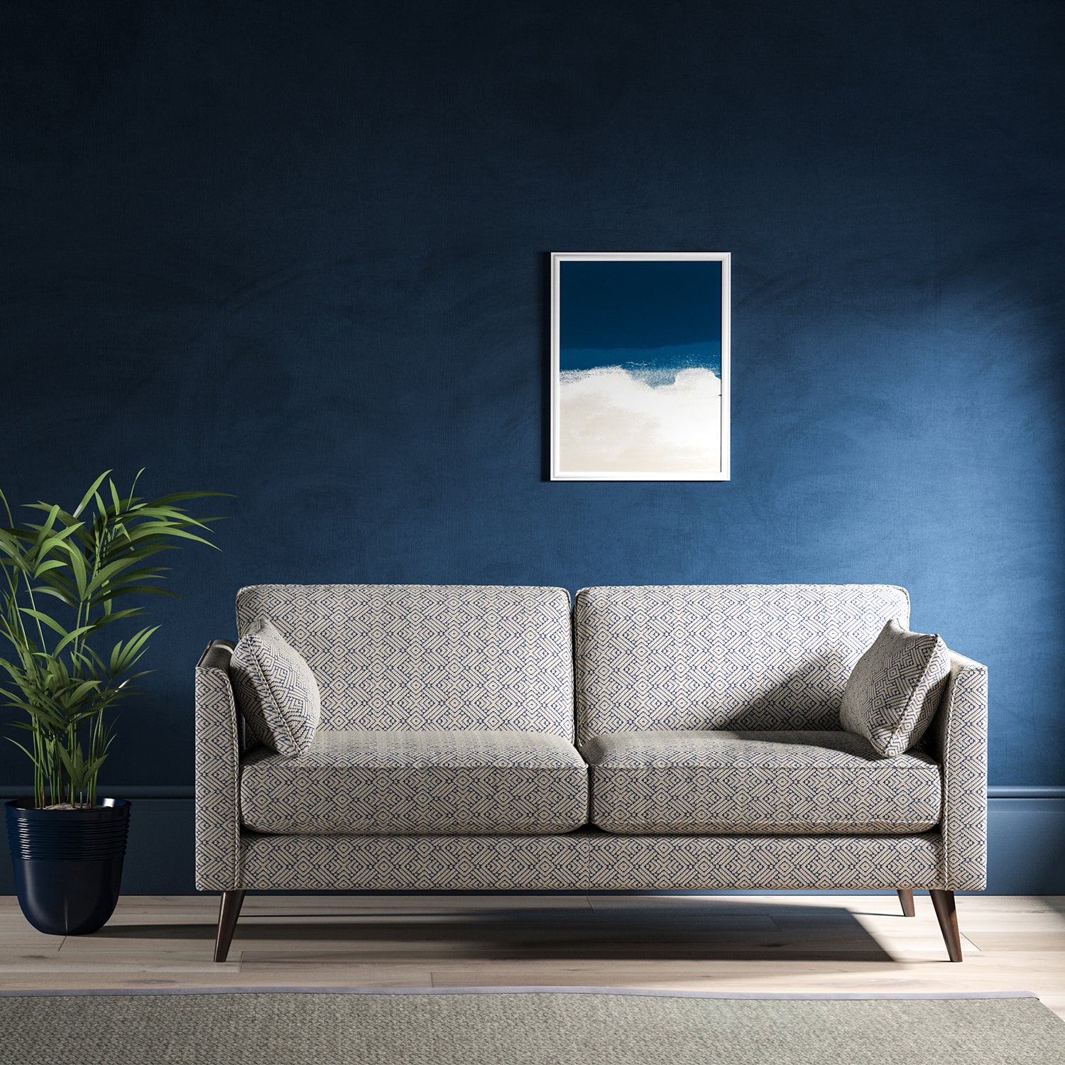 Sofa upholstered in a indigo blue and neutral geometric weave upholstery fabric