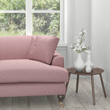 Sofa in a purple upholstery fabric with a geometric woven design