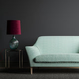 Sofa in a light blue and white wavy weave fabric.