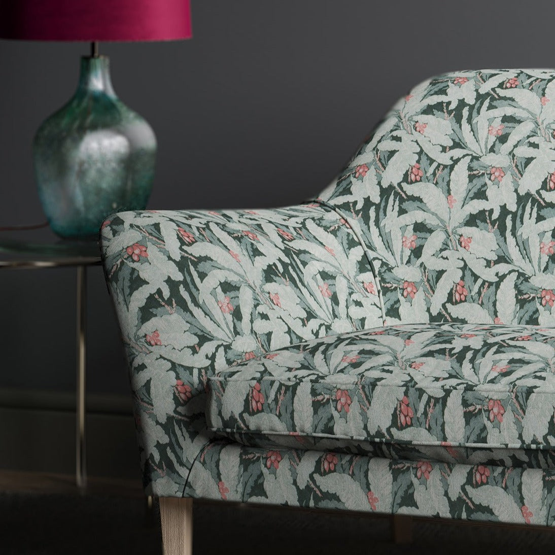 Sofa in a printed blue fabric with tropical leaf design