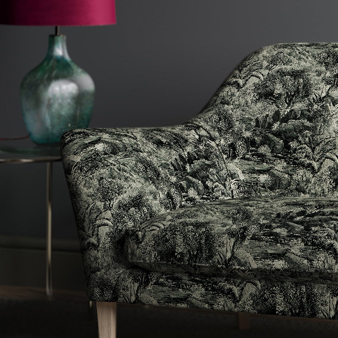 Luxurious printed velvet featuring a scenic/semi tropical design on a sofa