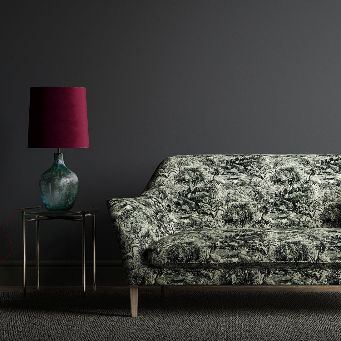 Luxurious printed velvet featuring a scenic/semi tropical design on a sofa
