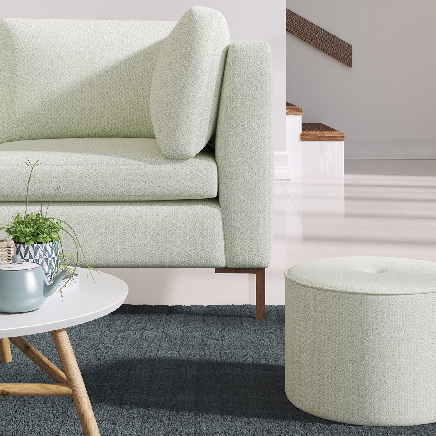 Living room with a contemporary sofa upholstered in a light blue semi-plain Scandi-style upholstery fabric
