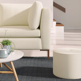 Living room with a contemporary sofa upholstered in a light pink semi-plain Scandi-style upholstery fabric