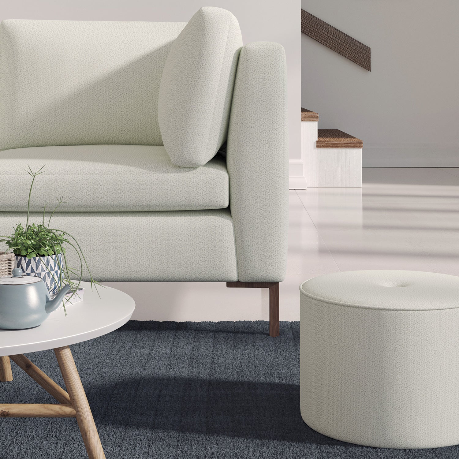 Living room with a contemporary sofa upholstered in a light grey semi-plain Scandi-style upholstery fabric