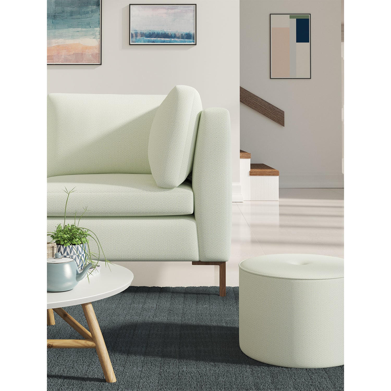 Living room with a contemporary sofa upholstered in a light blue semi-plain Scandi-style upholstery fabric