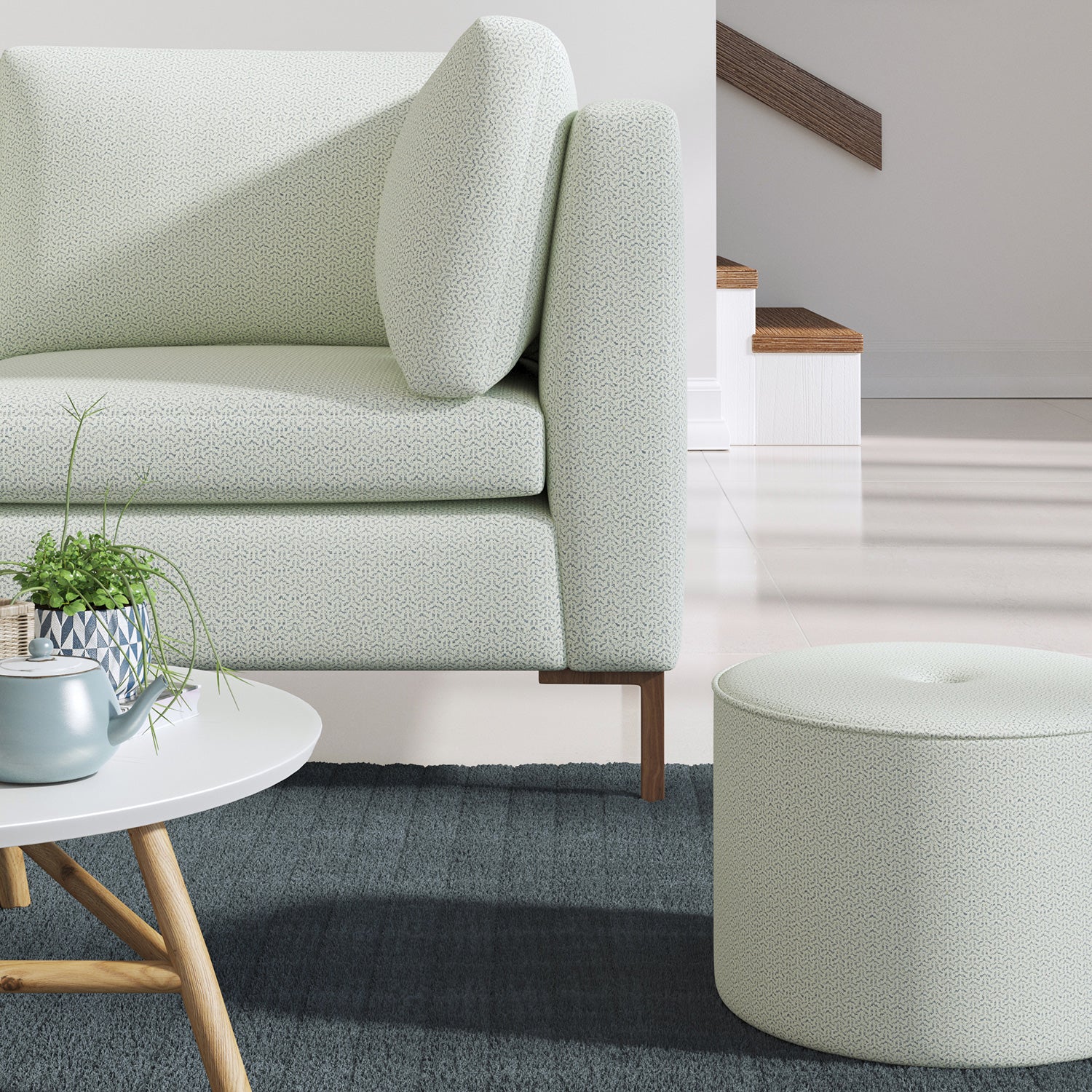 Living room with a contemporary sofa upholstered in a blue semi-plain Scandi-style upholstery fabric