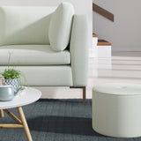 Living room with a contemporary sofa upholstered in a blue semi-plain Scandi-style upholstery fabric