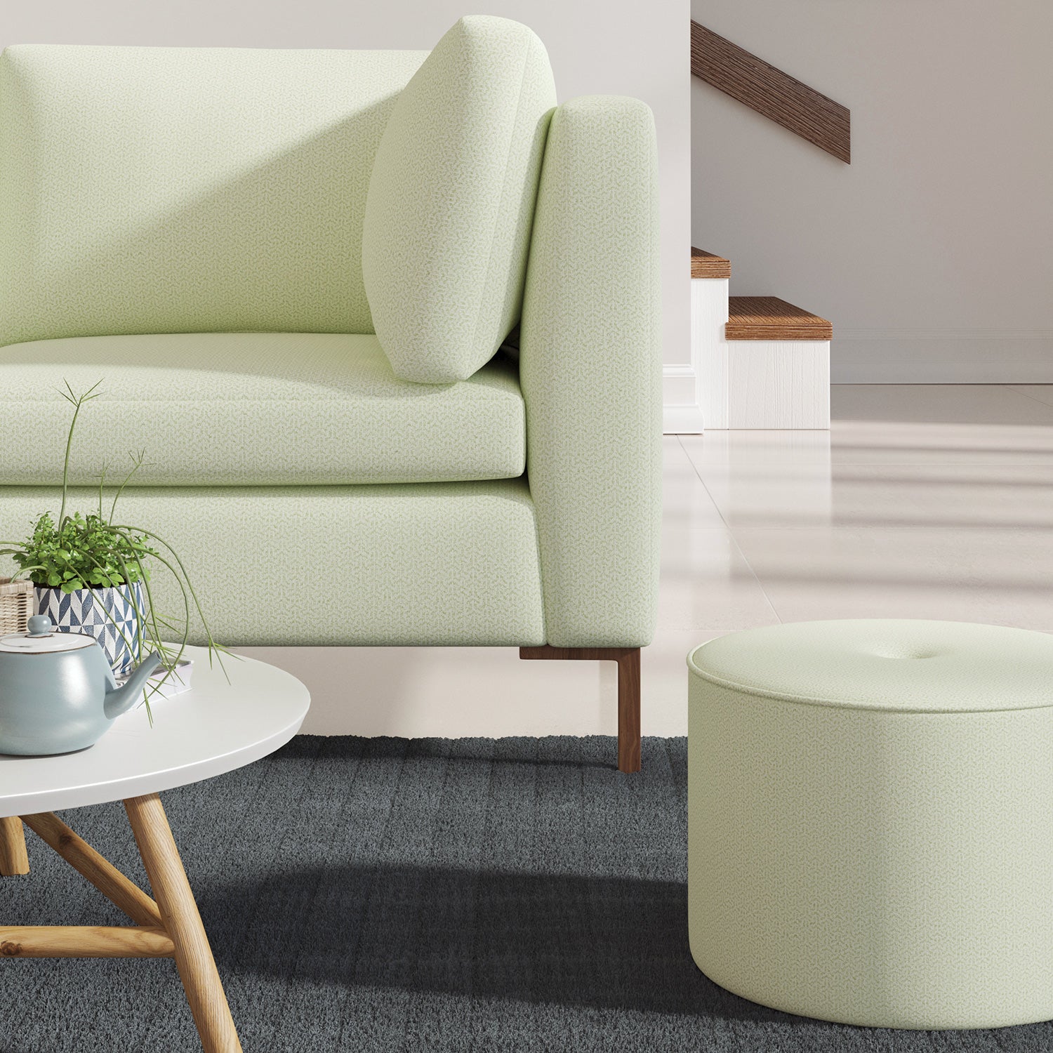 Living room with a contemporary sofa upholstered in a green semi-plain Scandi-style upholstery fabric