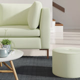 Living room with a contemporary sofa upholstered in a green semi-plain Scandi-style upholstery fabric