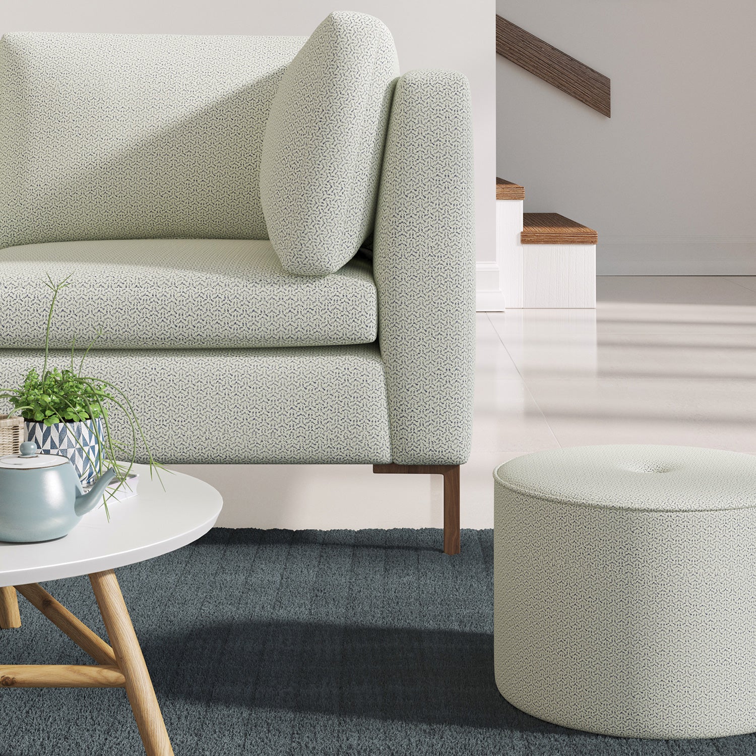 Living room with a contemporary sofa upholstered in a blue semi-plain Scandi-style upholstery fabric