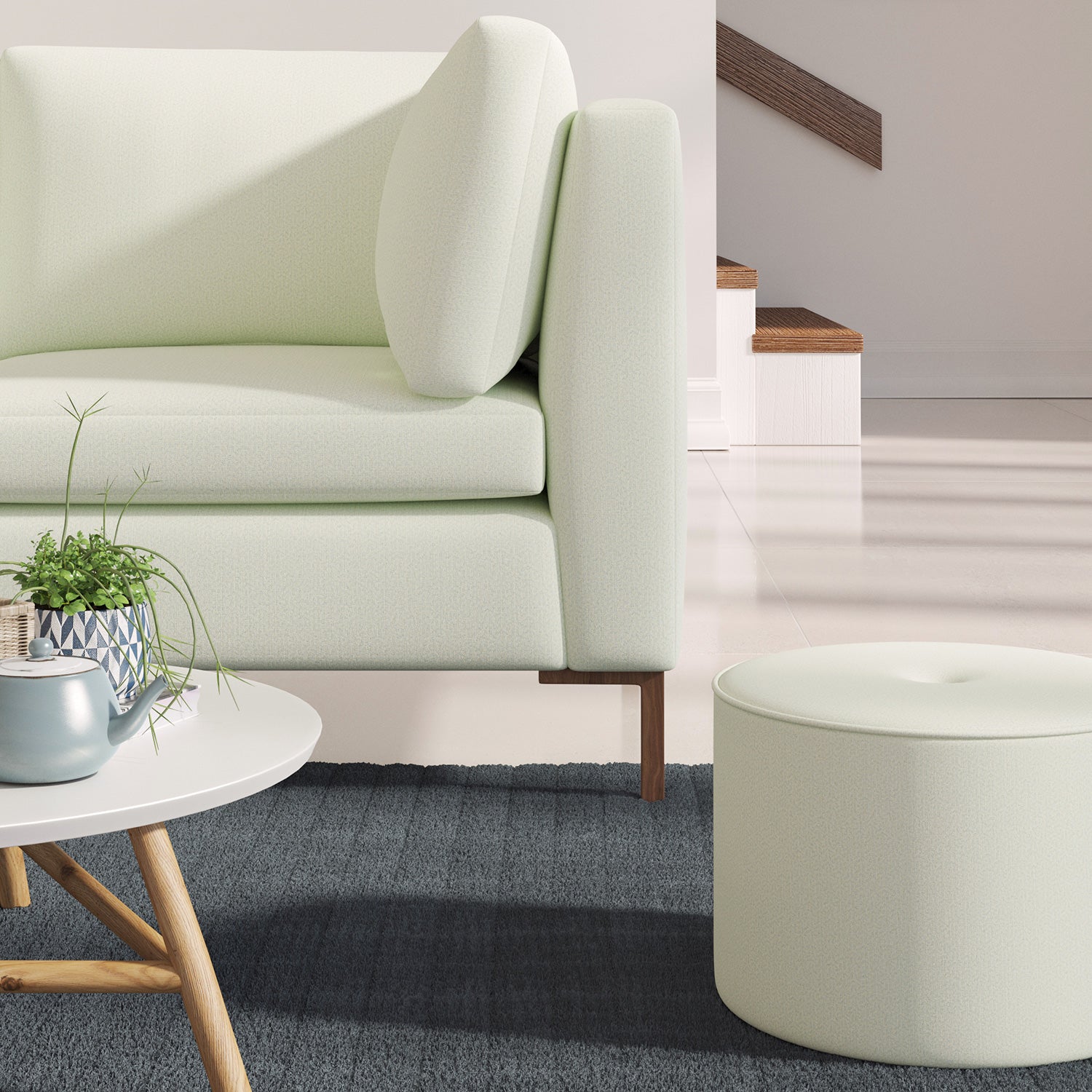 Living room with a contemporary sofa upholstered in a sky blue semi-plain Scandi-style upholstery fabric