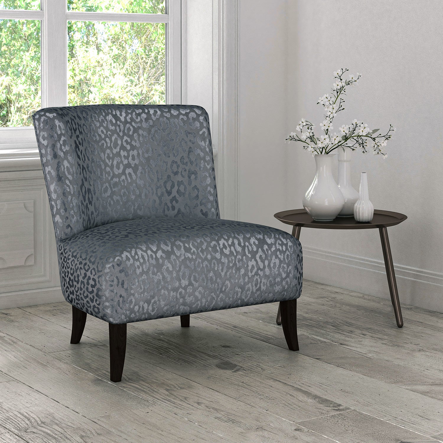 Chair upholstered in a blue stain resistant animal print upholstery fabric
