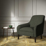 A green woven fabric on an armchair.