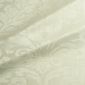 Fabric swatch of a contemporary damask fabric in a light green colour for upholstery and curtains.