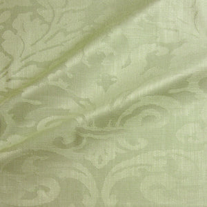 Fabric swatch of a contemporary damask fabric in a light green colour for upholstery and curtains.