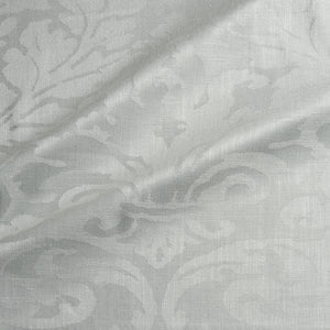 Fabric swatch of a contemporary damask fabric in a cream colour for upholstery and curtains.