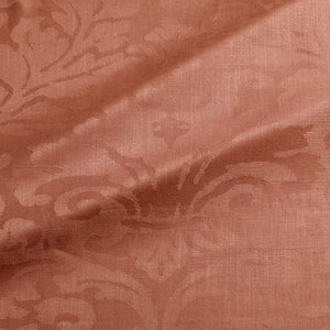 Fabric swatch of a contemporary damask fabric in a terracotta colour for upholstery and curtains.